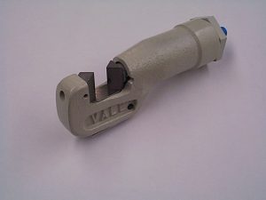 Industrial pipe cutter tool on white background.